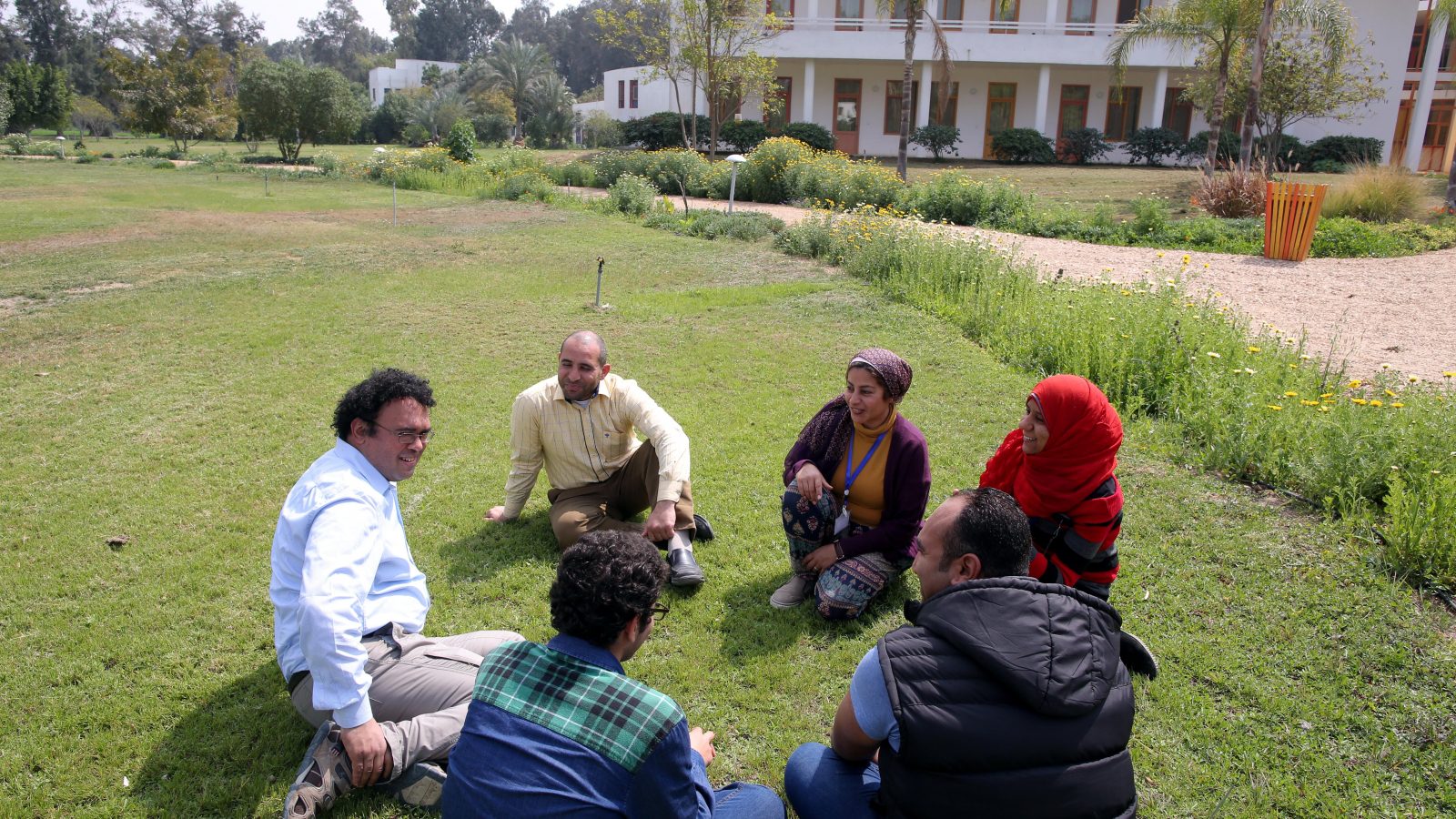 Egyptian facilitator Mohamed Abdel Mohsen ElMongy (L) speaks with Egyptian civil society actors at Sekem farm in Belbeis, Sharqia Governorate