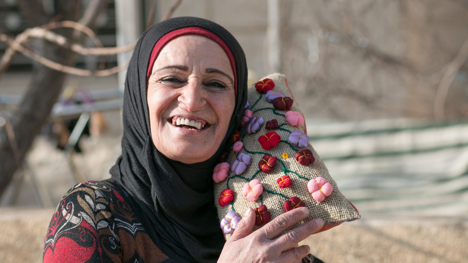 Souhayla beneficiary of the EU-funded project Dawric posing with one of her creations, Douris, Lebanon